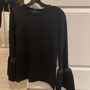 Women’s long sleeve black top with bell shaped cuffs